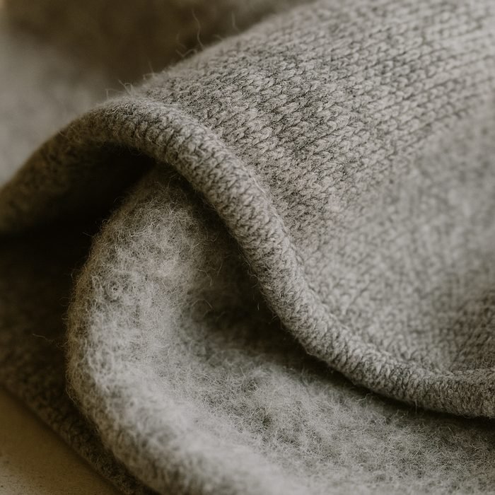 Close-up of heavyweight brushed cotton fleece in heather grey showing the loopback inner face