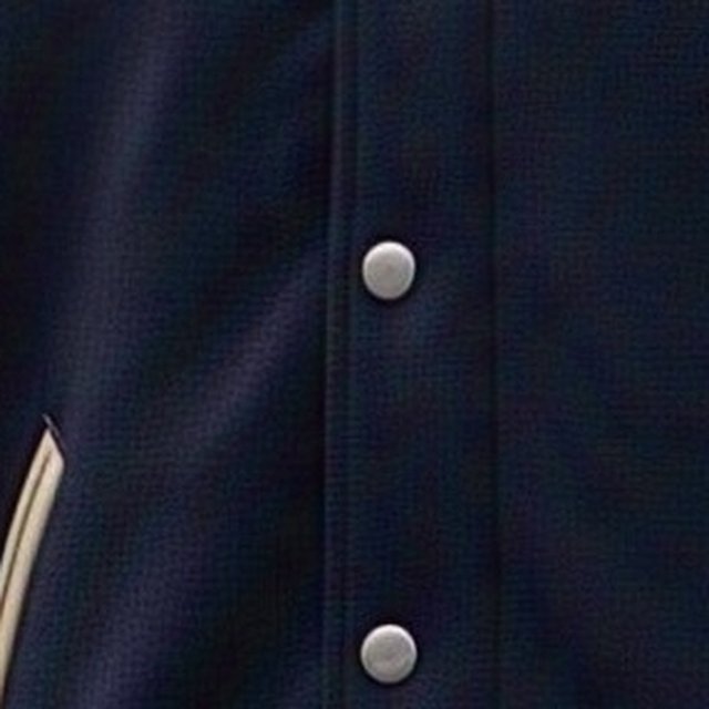 Close-up of the navy melton wool-look body fabric of a varsity jacket