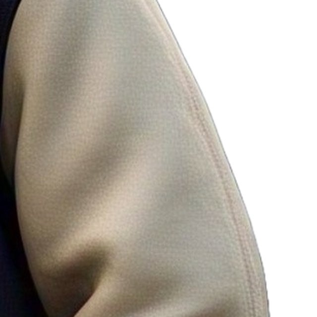 Close-up of the cream leather-look sleeve of a varsity jacket showing the grain and the seam