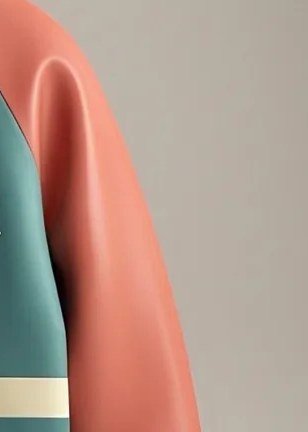 Close-up of a coral leather-look sleeve joined to a teal body at the raglan seam