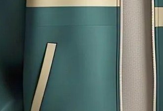 Close-up of a contrast-bound welt pocket set into a teal jacket body