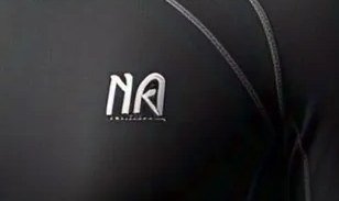 Close-up of a small printed chest mark on matte black performance fabric