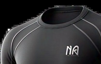Close-up of the raglan shoulder seam and bound neckline on a black compression top