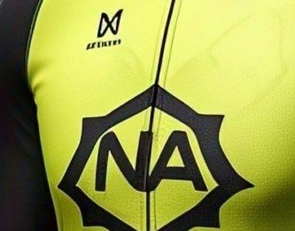 Close-up of the applied hexagon chest mark on the hi-vis yellow panel of the cycling jersey, beside the front zip