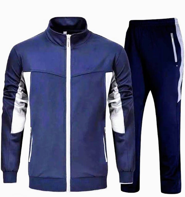 Dark green zip-through track jacket with a stand collar shown on a hanger with matching flared trousers